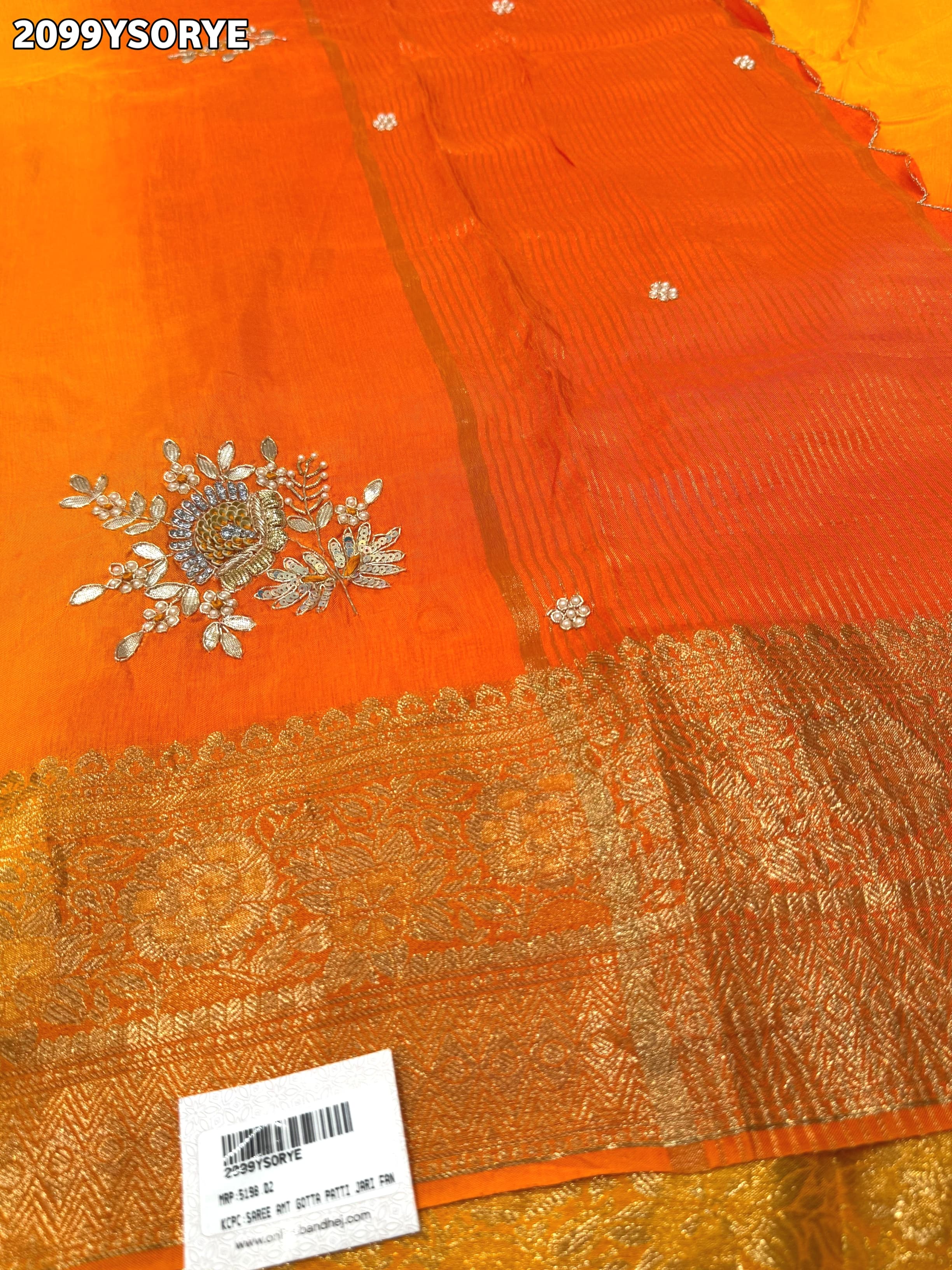 By Orange saree with gold border and floral embroidery