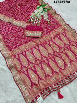 A red and gold saree in rani colour