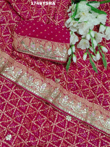 A red and gold saree in rani colour