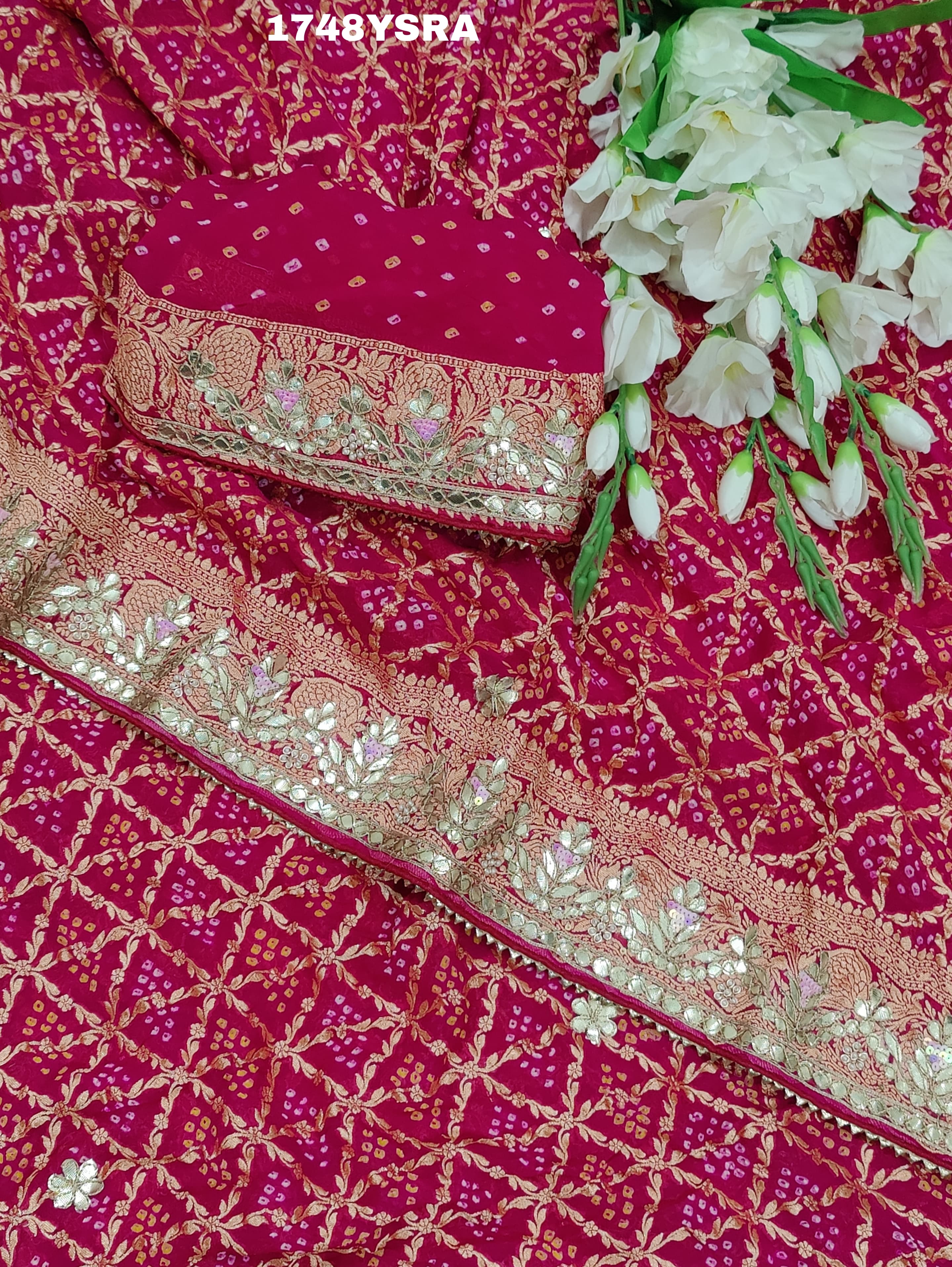 A red and gold saree in rani colour