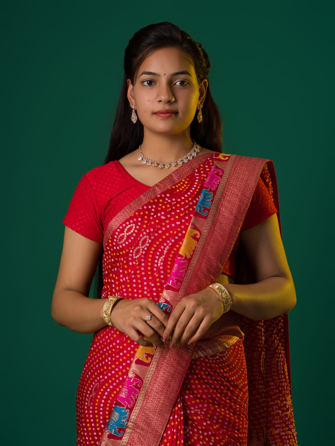 A red munga silk saree with zari border.