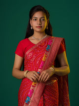 A red munga silk saree with zari border.