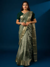 A green and gold Banarasi style saree with zari border.