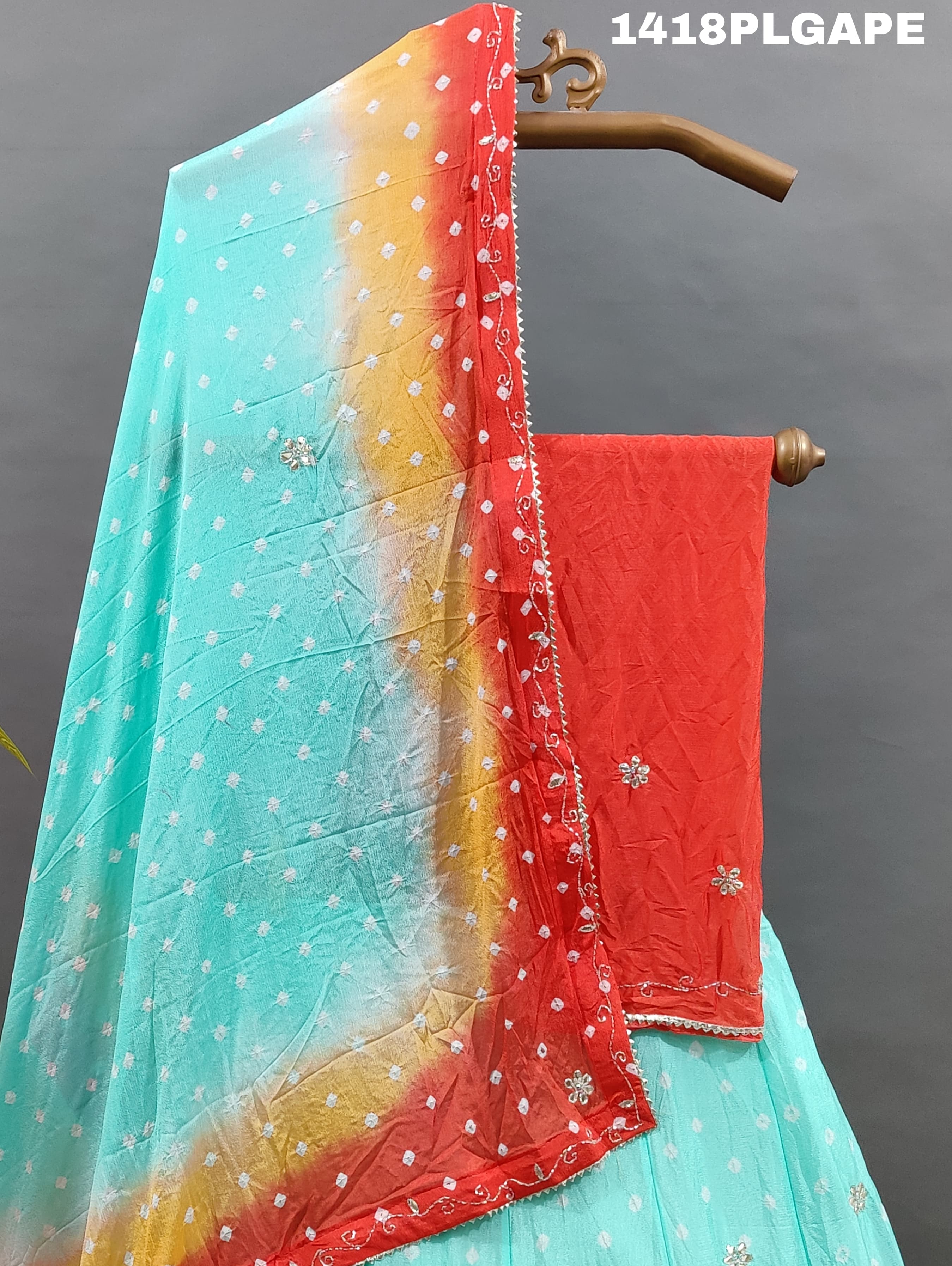 A Lehenga with a multi-color bandhani pattern and cutdana