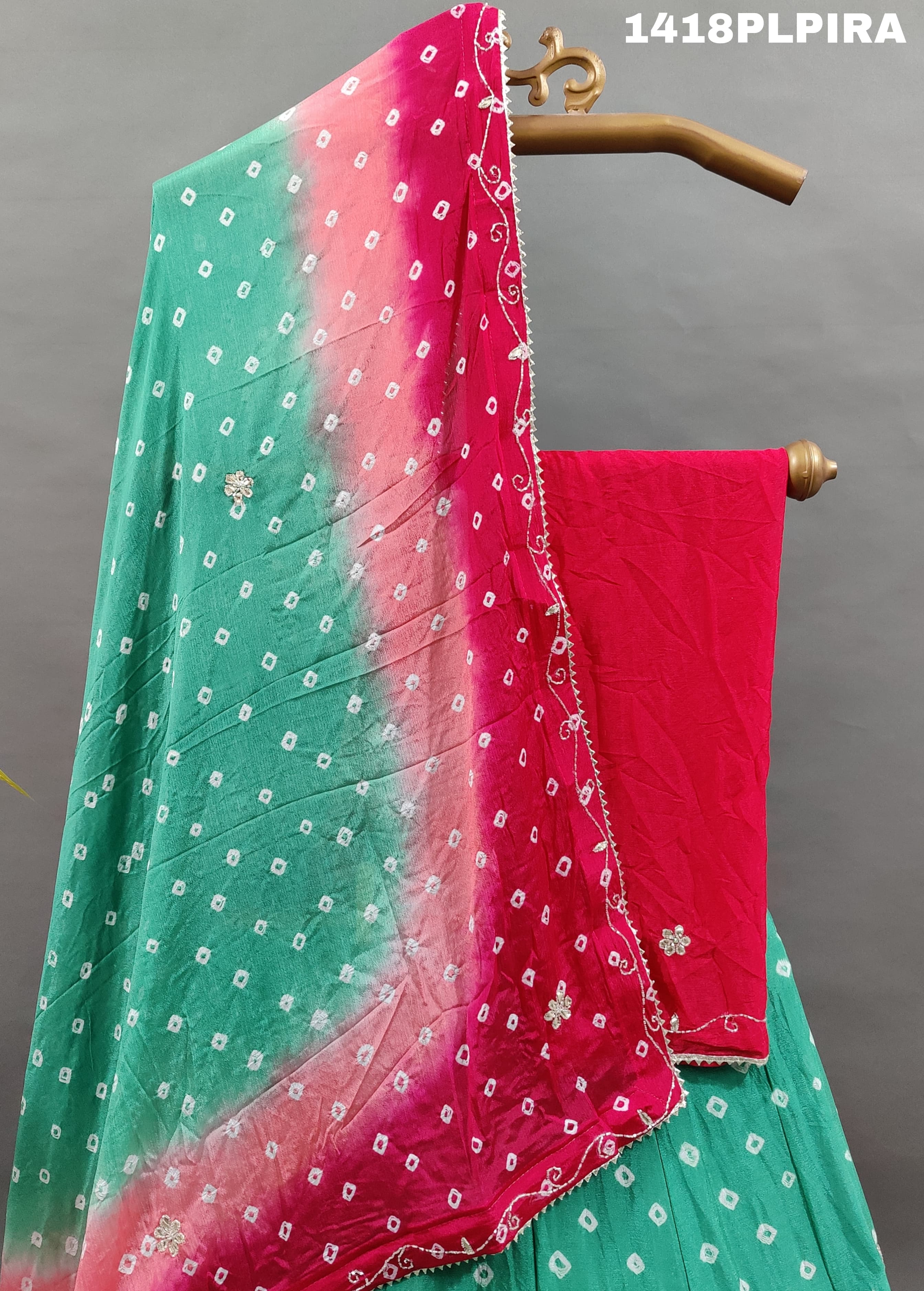 A traditional multicolor bandhani lehenga with cutdana work