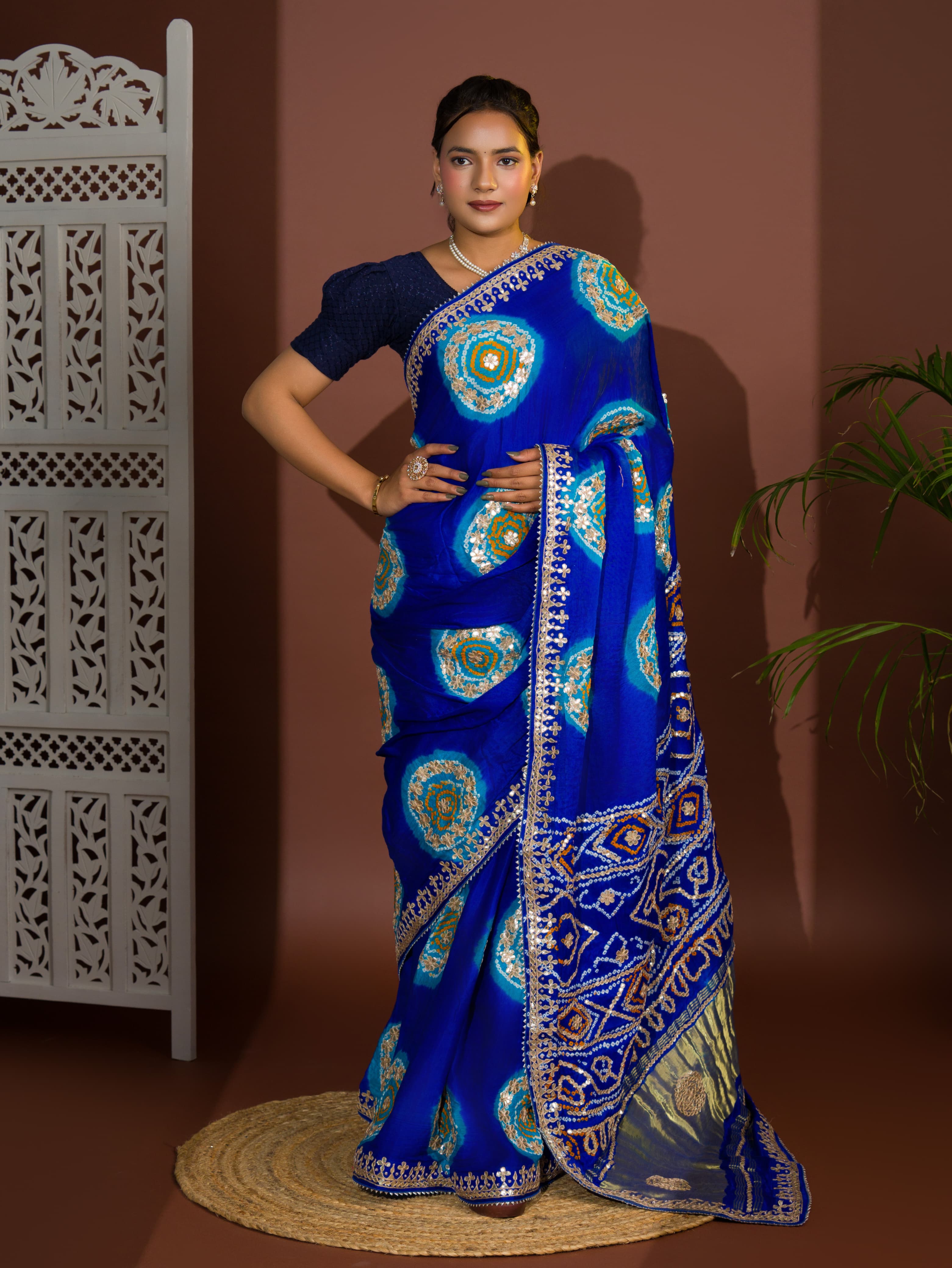A blue and firozi colored pure gaji silk saree with bandhej gotapatti laddu design