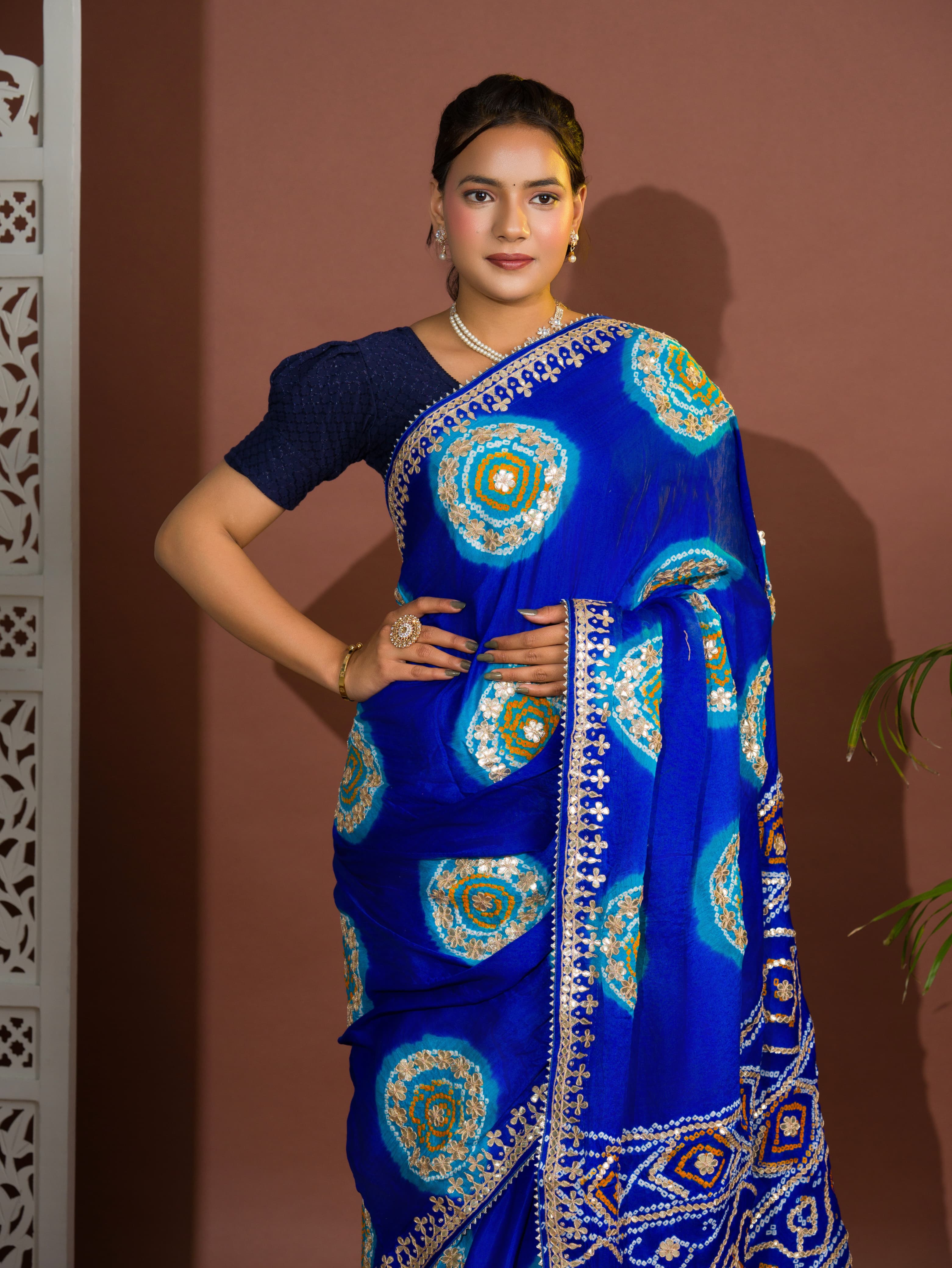 A blue and firozi colored pure gaji silk saree with bandhej gotapatti laddu design