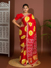 A red saree with bandhej style and gotapatti work in red and yellow colour