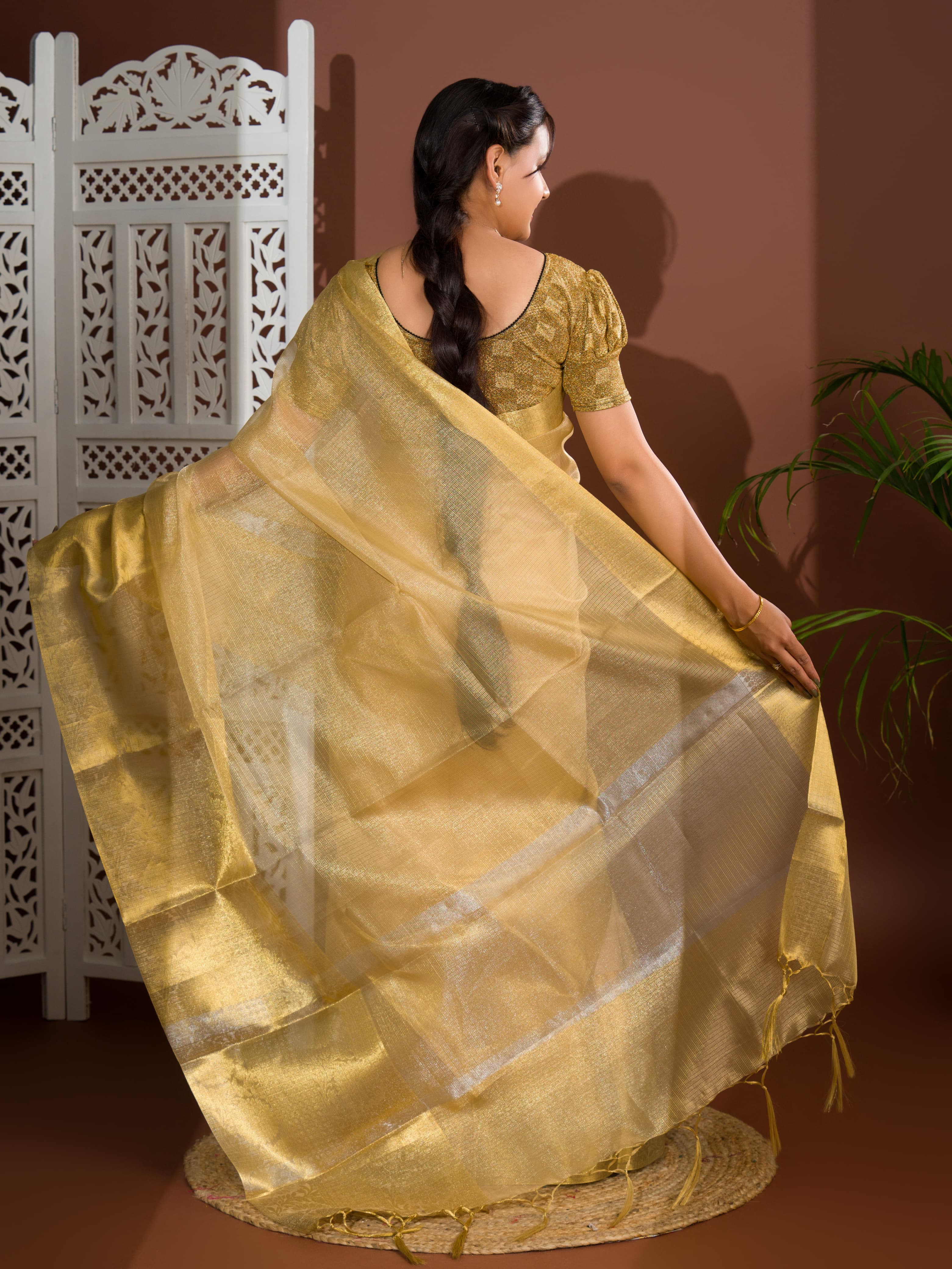 A golden Banarasi handloom saree with tissue silk