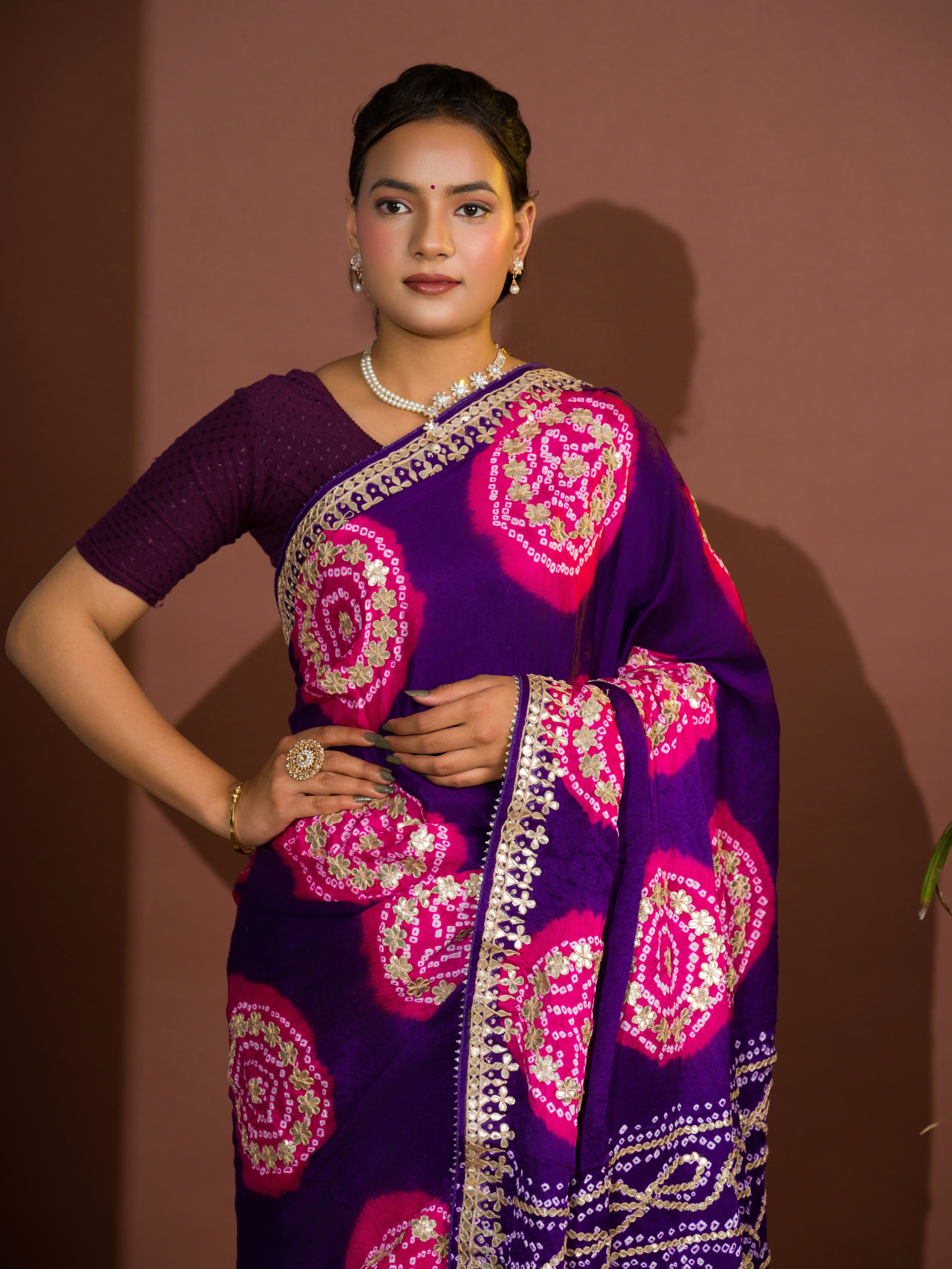A purple and pink bandhej gotapatti saree