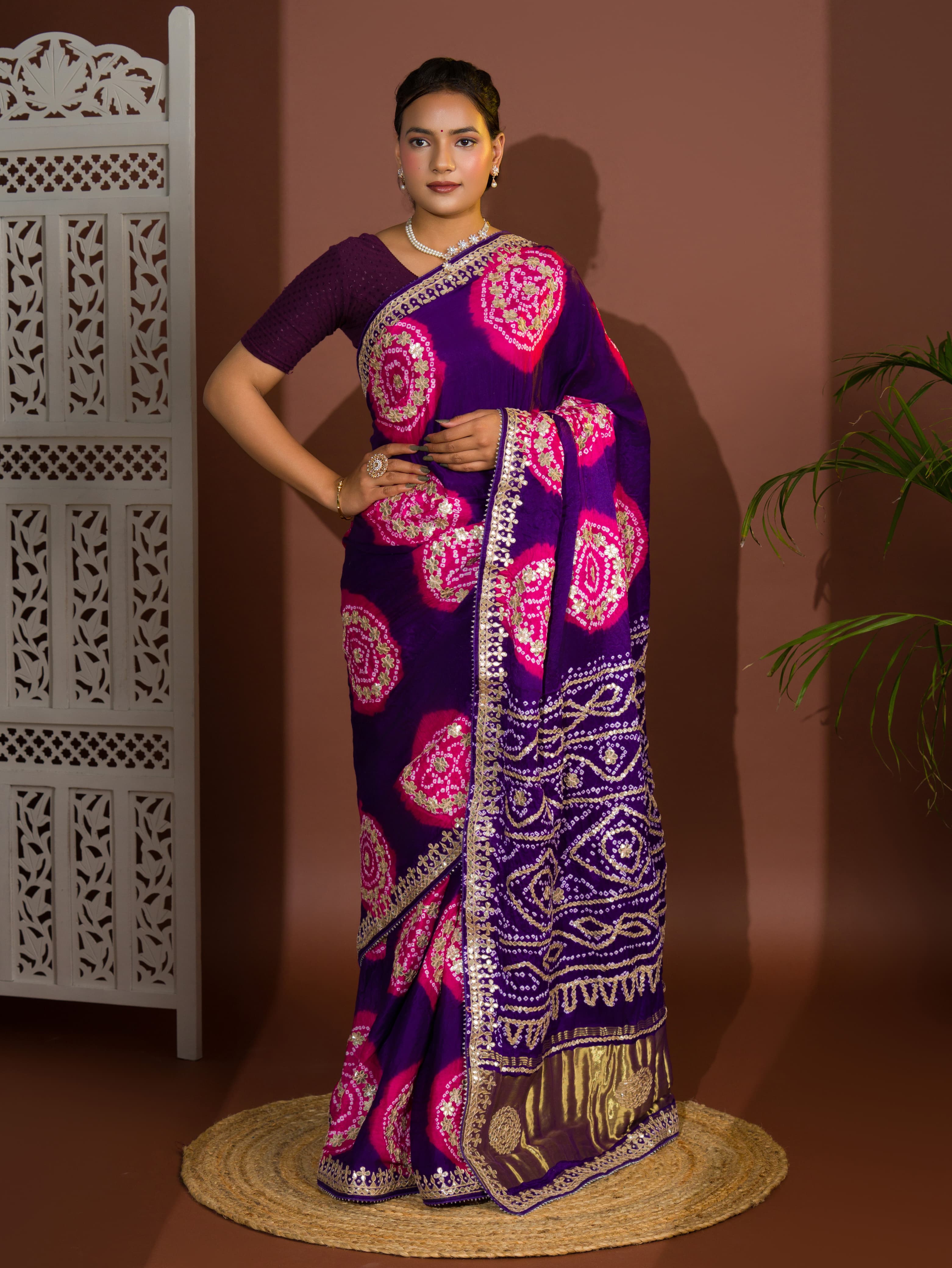 A purple and pink bandhej gotapatti saree