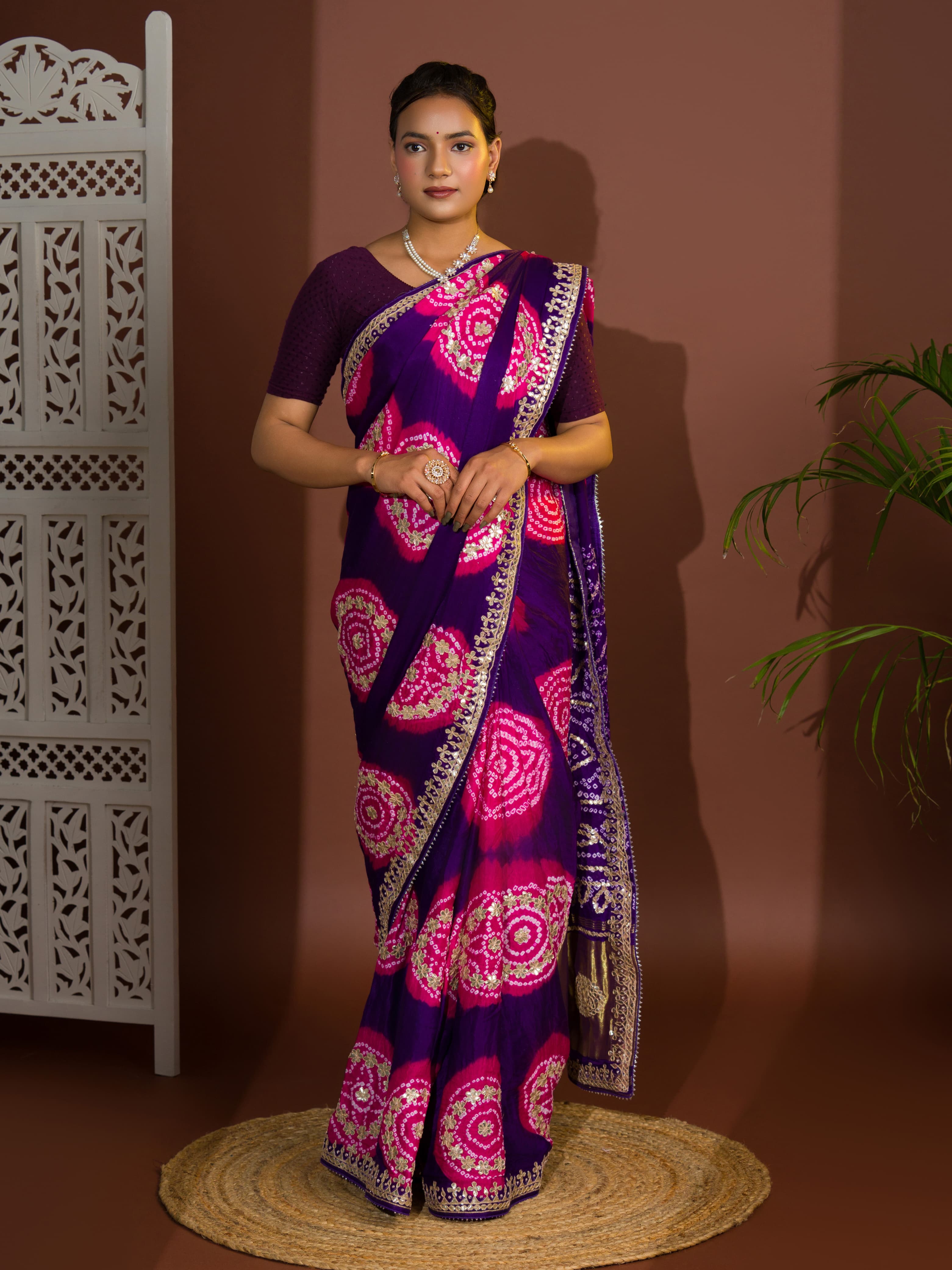 A purple and pink bandhej gotapatti saree