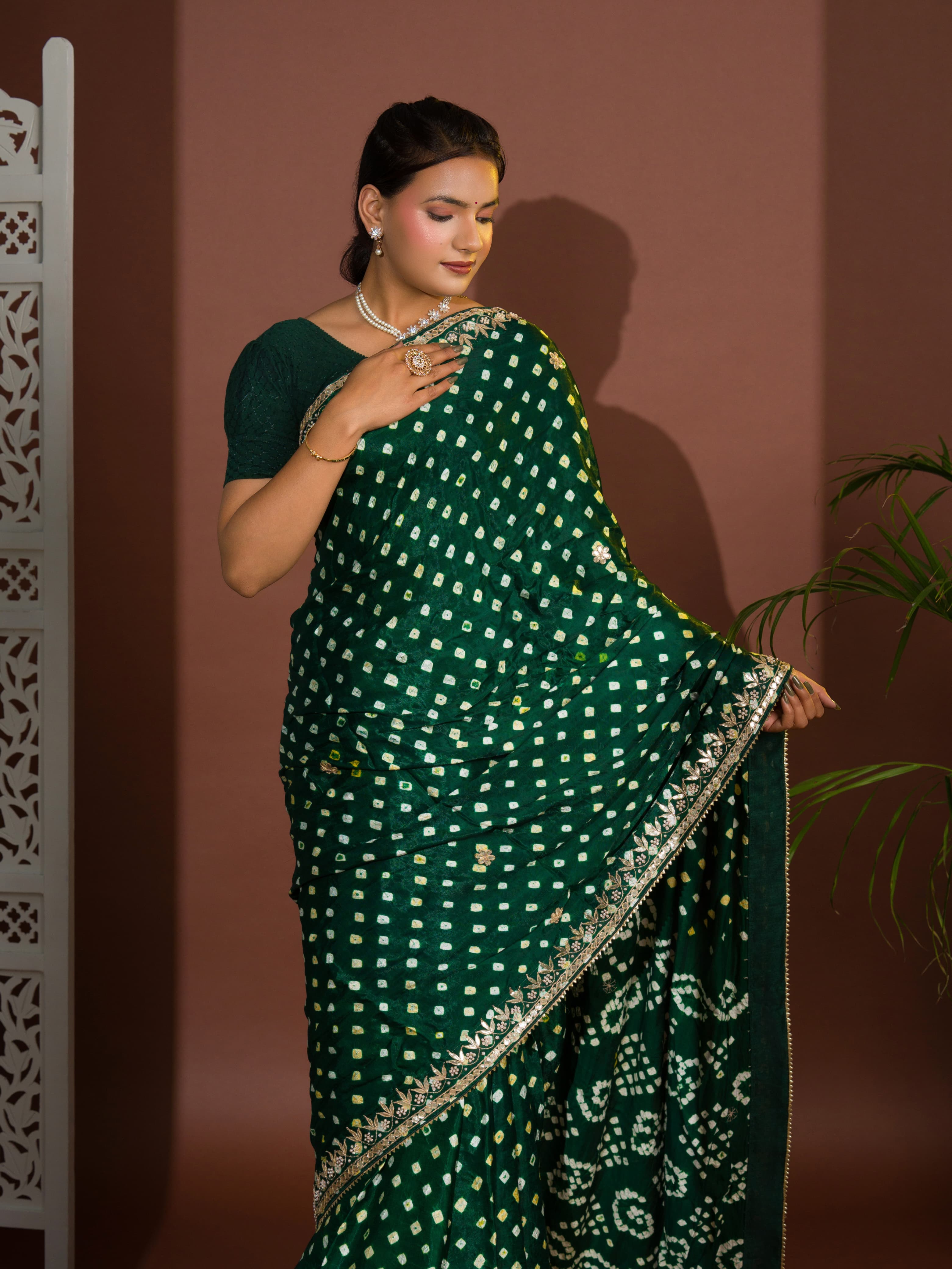 A green saree with bandhej and gotapatti work.