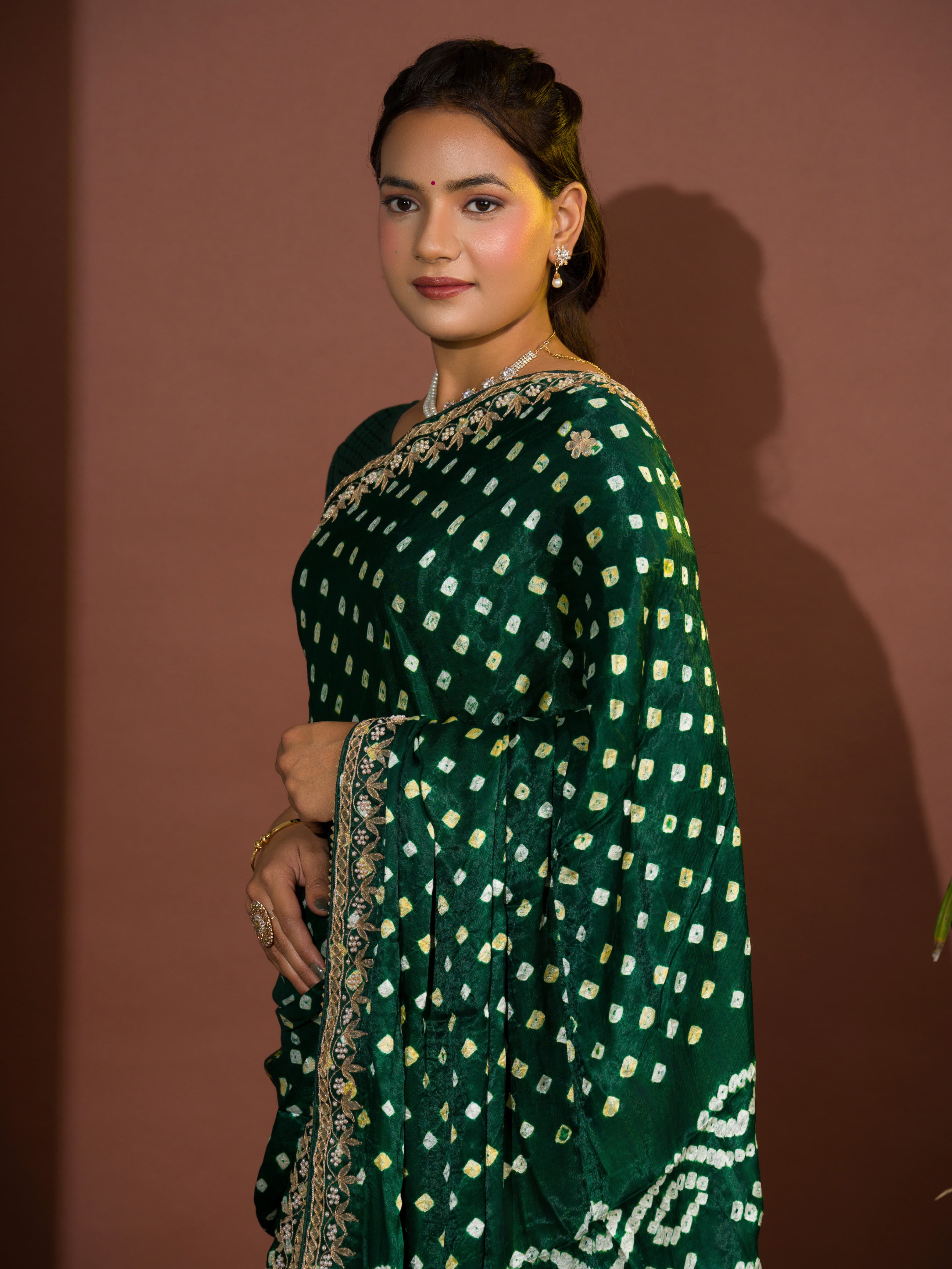 A green saree with bandhej and gotapatti work.