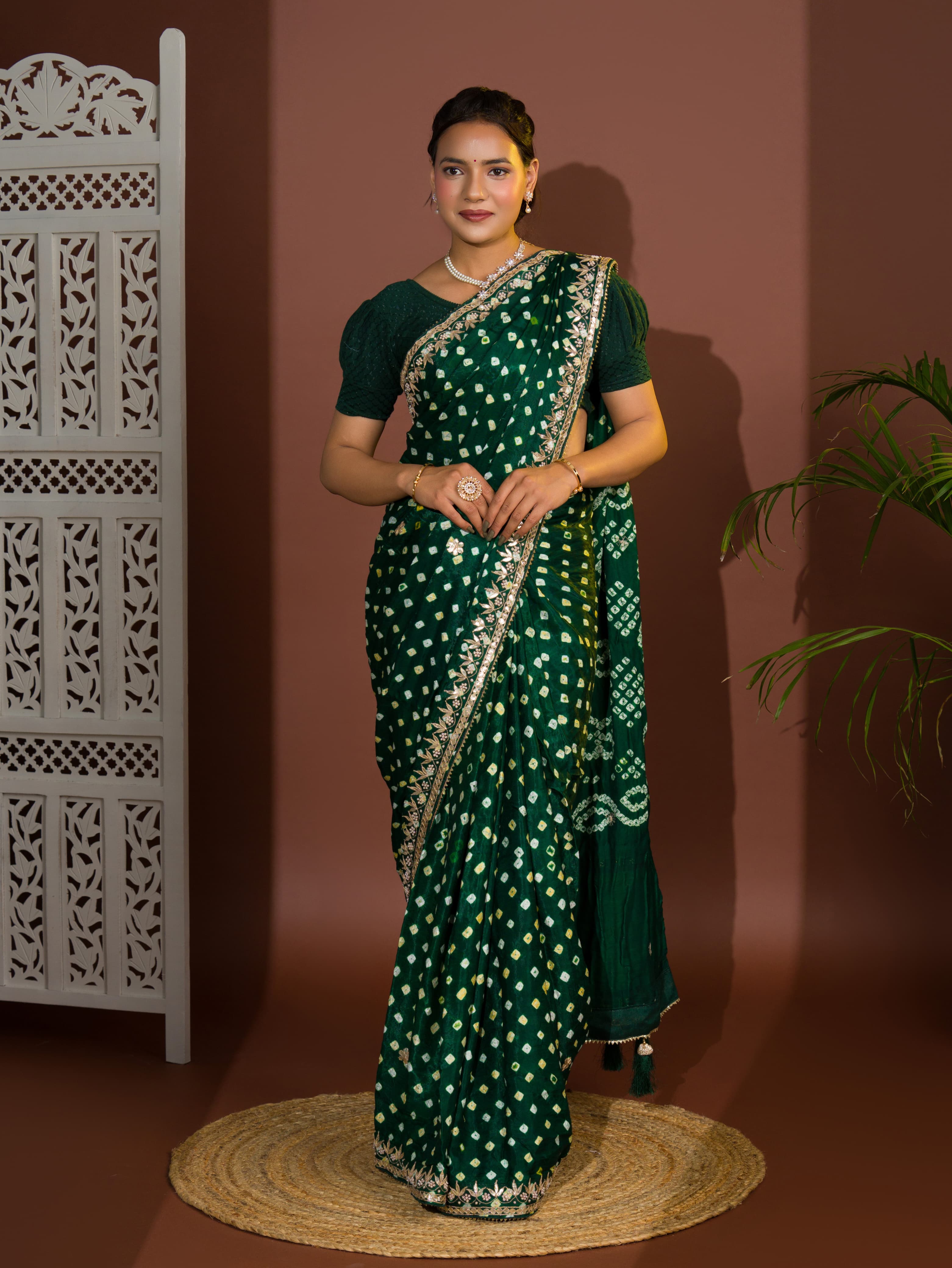 A green saree with bandhej and gotapatti work.
