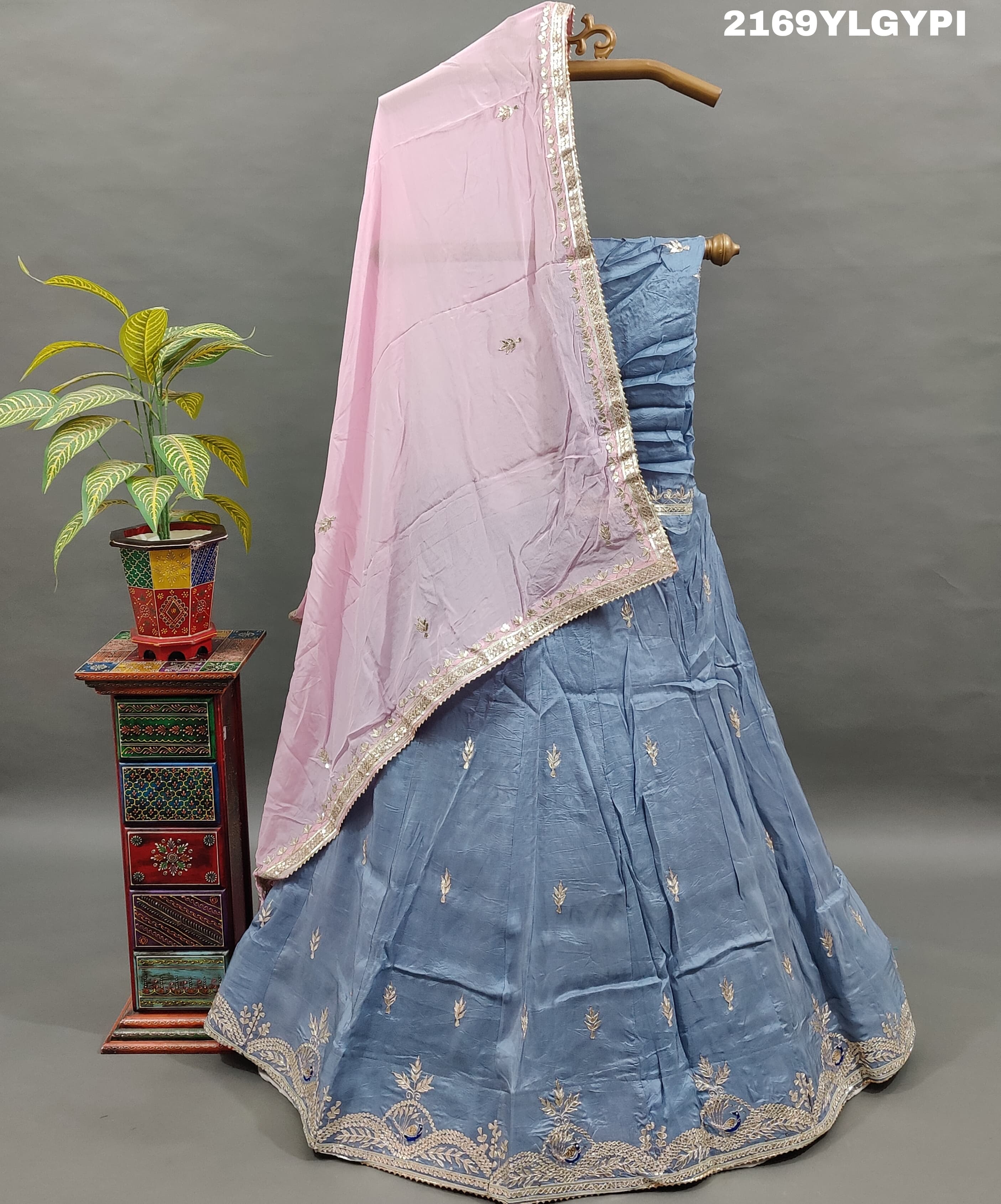 A traditional wear lehanga in blue and pink with floral gotapatti work