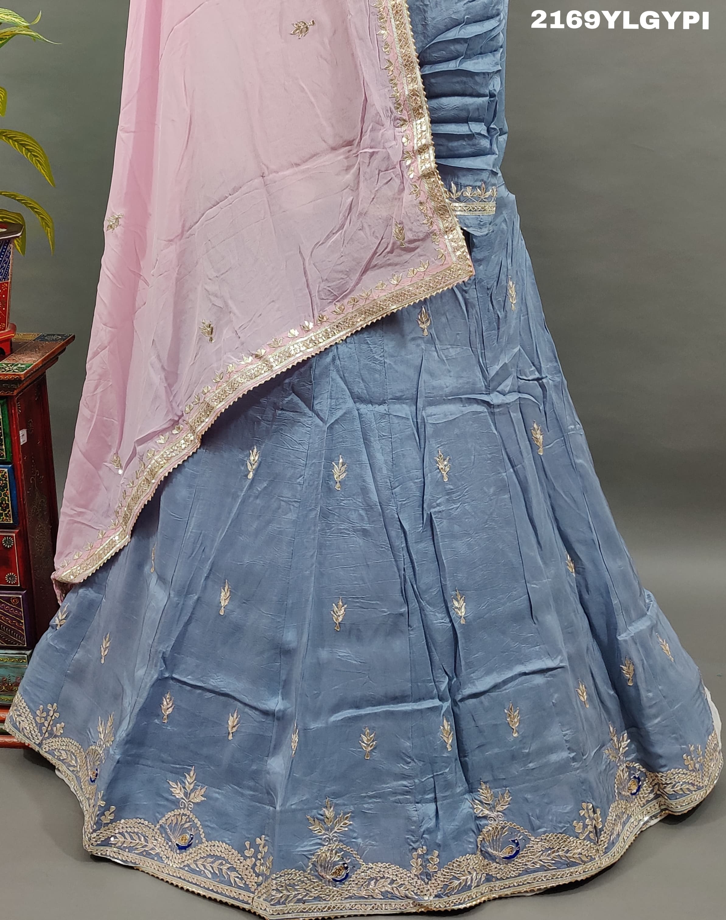 A traditional wear lehanga in blue and pink with floral gotapatti work