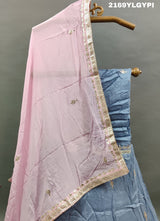 A traditional wear lehanga in blue and pink with floral gotapatti work