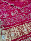 A pink and red bandhani style saree with gotapatti work
