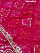 A pink and red bandhani style saree with gotapatti work