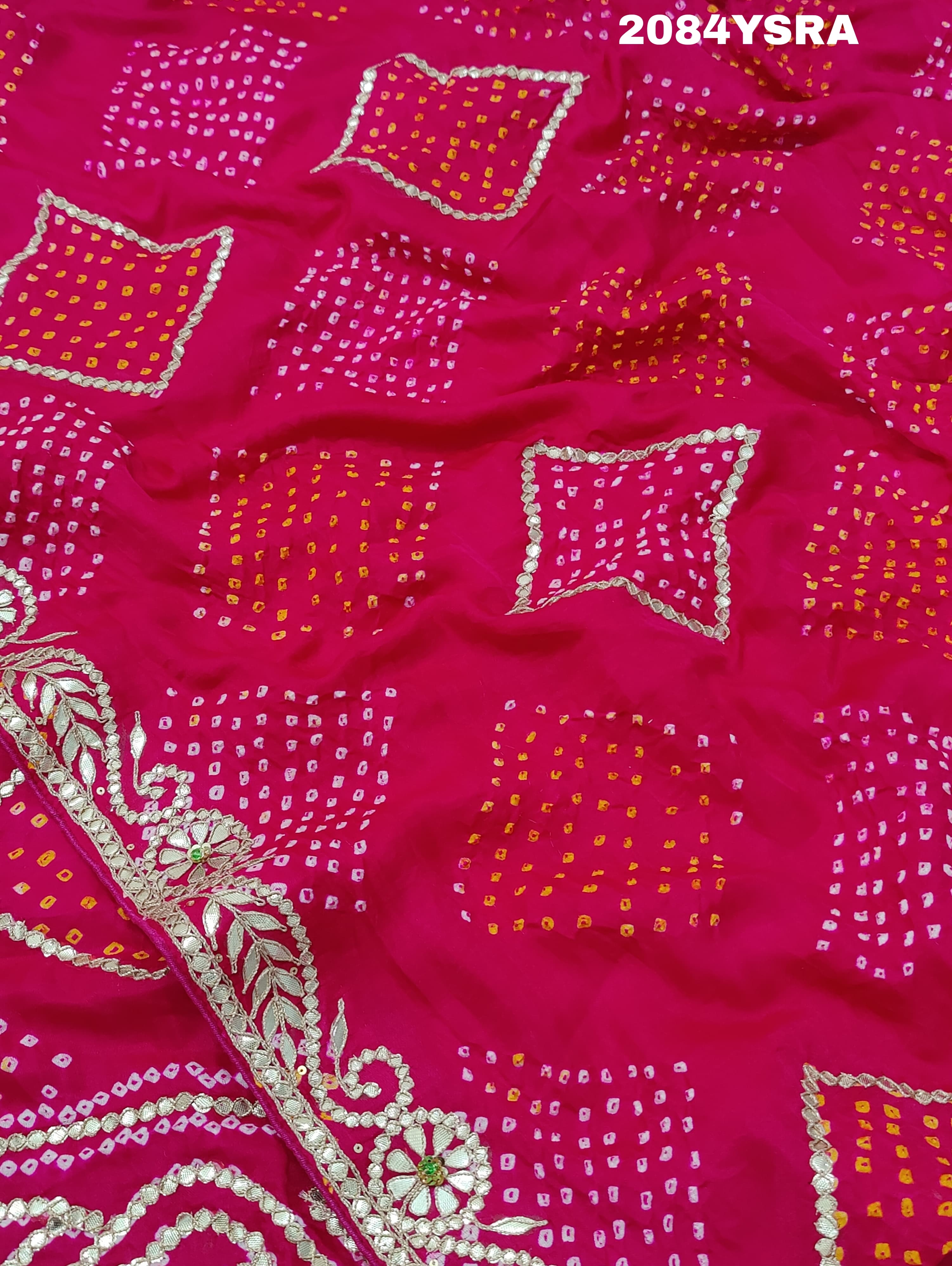 A pink and red bandhani style saree with gotapatti work