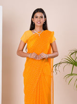 A yellow chiffon saree with a bandhani pattern