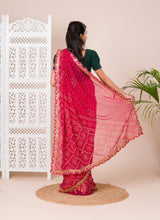 Ared and pink bandhani style saree with gotapatti embellishments and a mangal patha design
