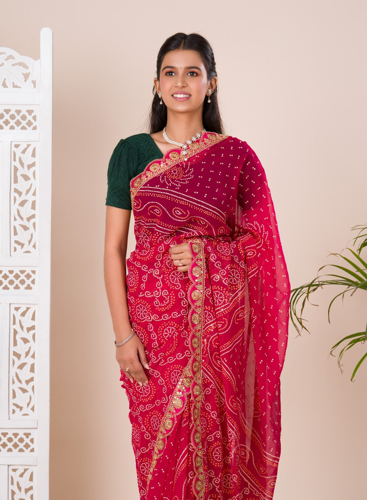 Ared and pink bandhani style saree with gotapatti embellishments and a mangal patha design