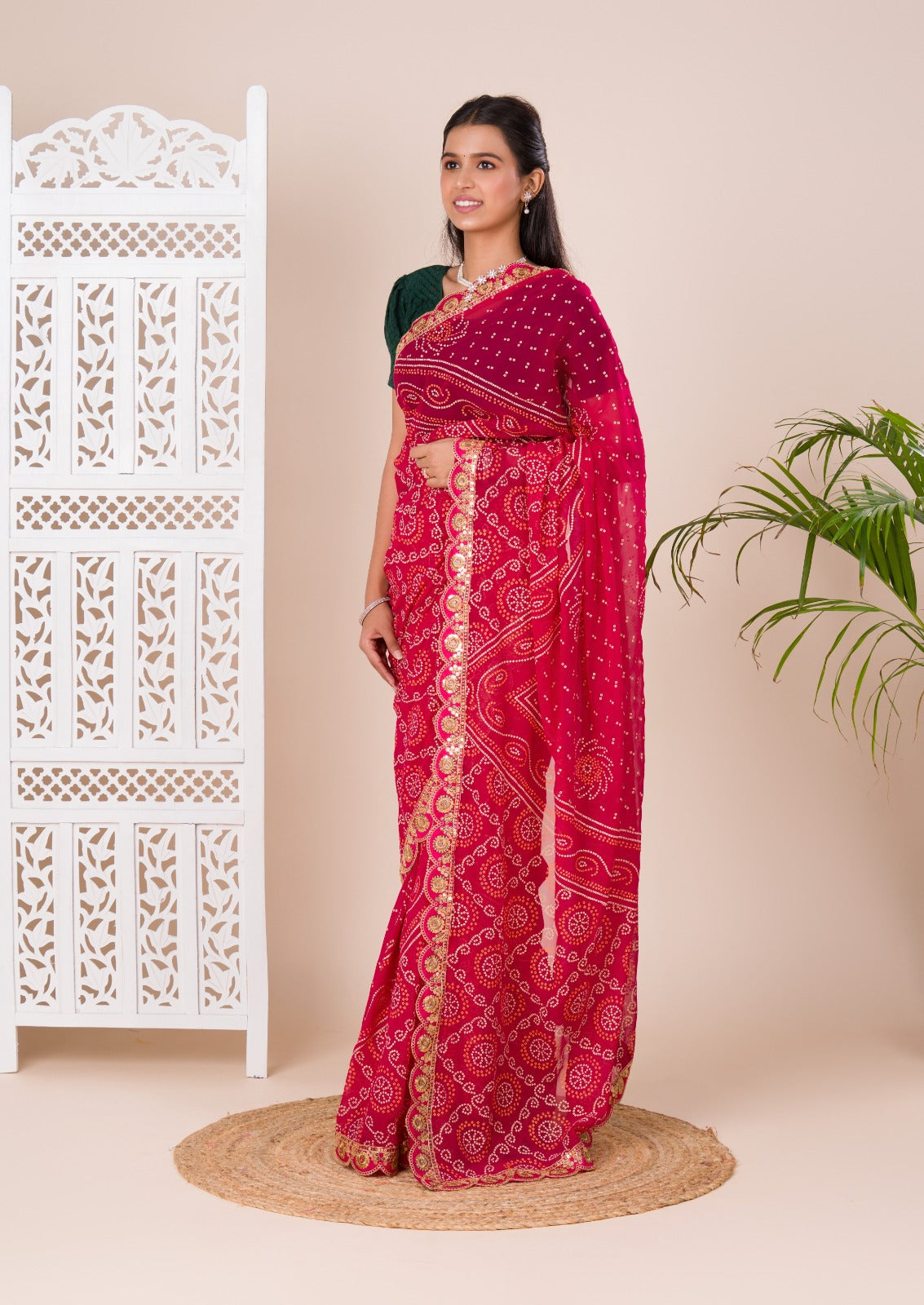 Ared and pink bandhani style saree with gotapatti embellishments and a mangal patha design
