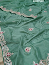 A green saree with tissue silk texture and Gotapatti work embroidery.