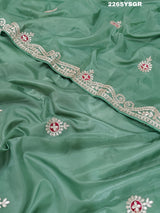 A green saree with tissue silk texture and Gotapatti work embroidery.