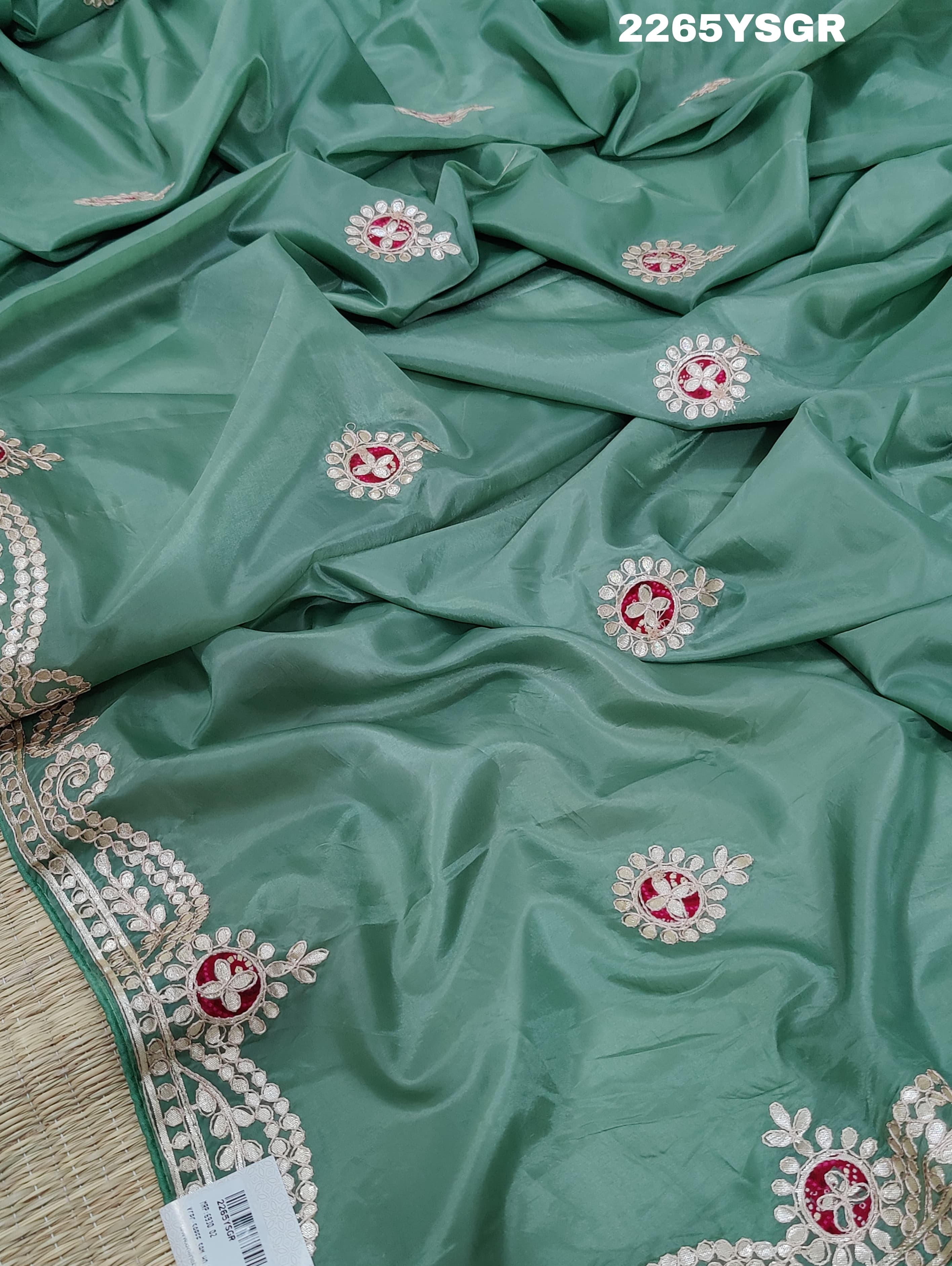 A green saree with tissue silk texture and Gotapatti work embroidery.