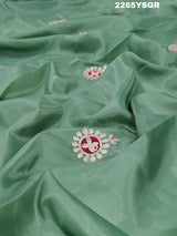 A green saree with tissue silk texture and Gotapatti work embroidery.
