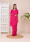A pink saree with bandhani pattern and aari tari work