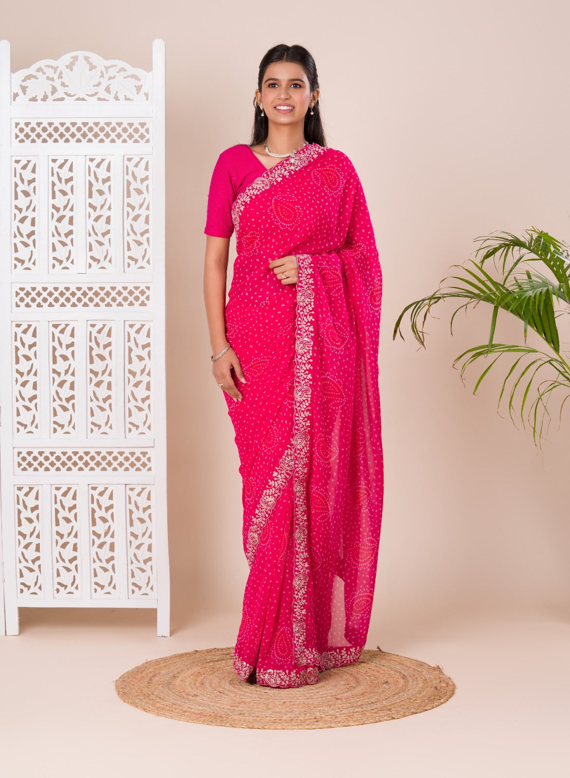 A pink saree with a bandhani pattern