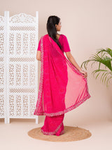 A pink saree with a bandhani pattern