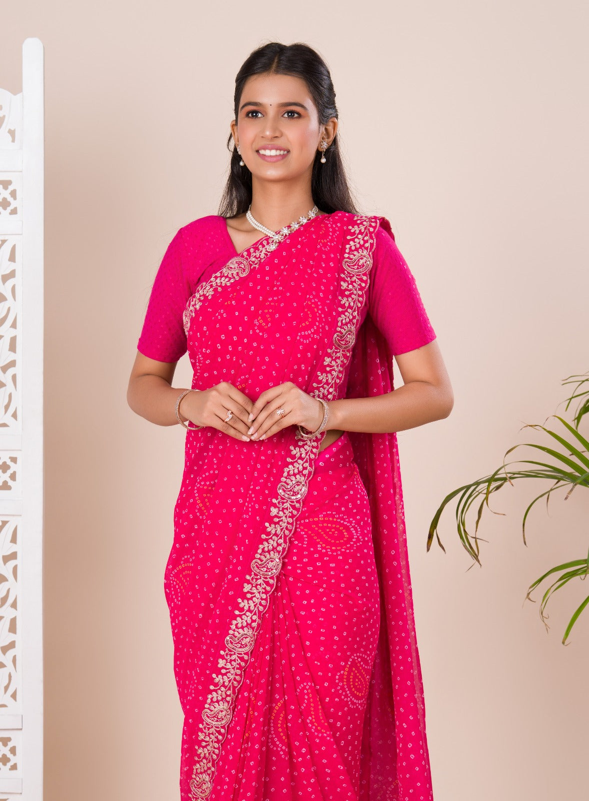 A pink saree with a bandhani pattern