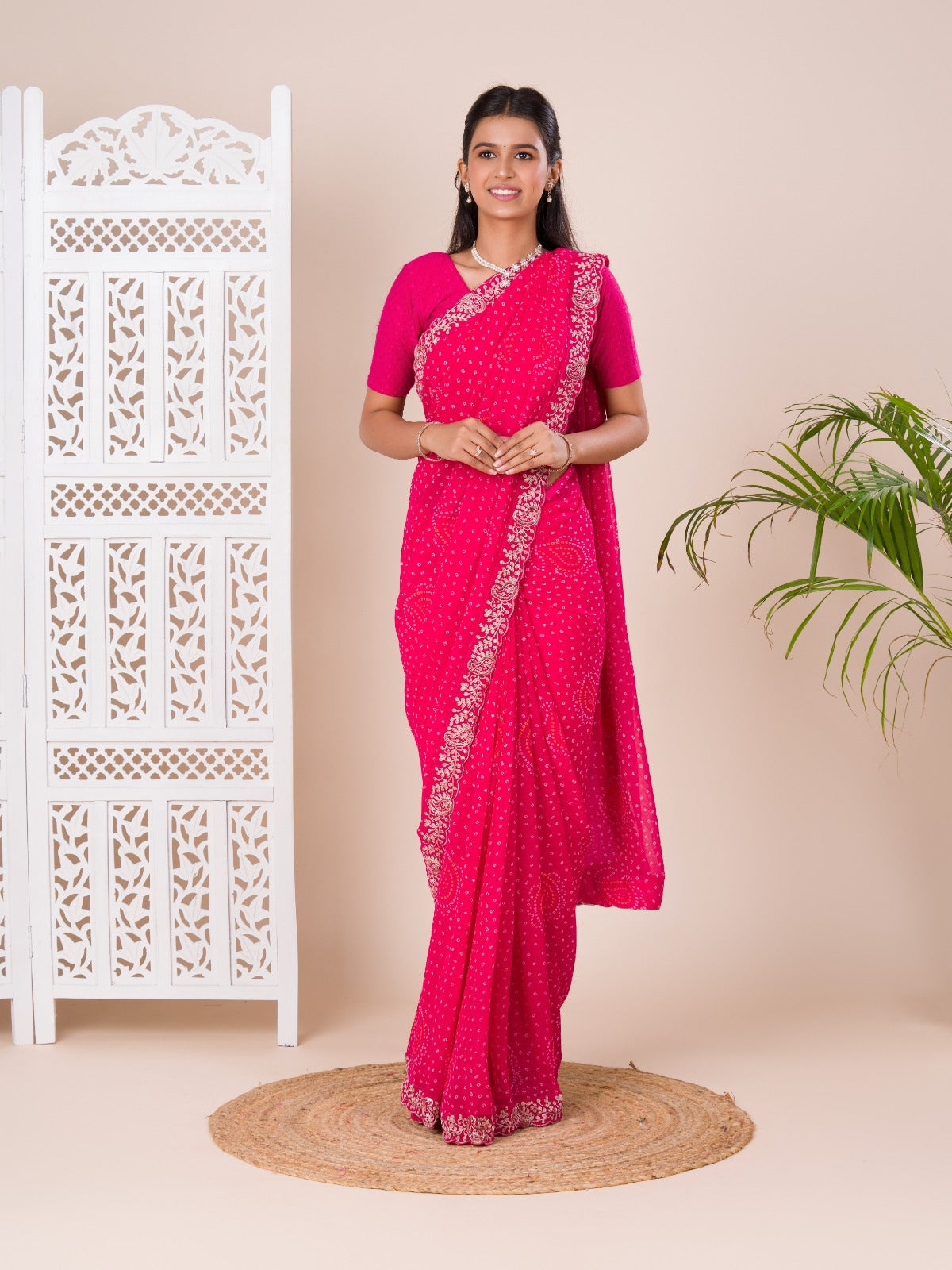 A pink saree with a bandhani pattern