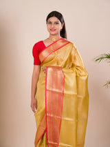 A Banarasi style saree in yellow and red with a tissue silk pattern, suitable for festival wear.