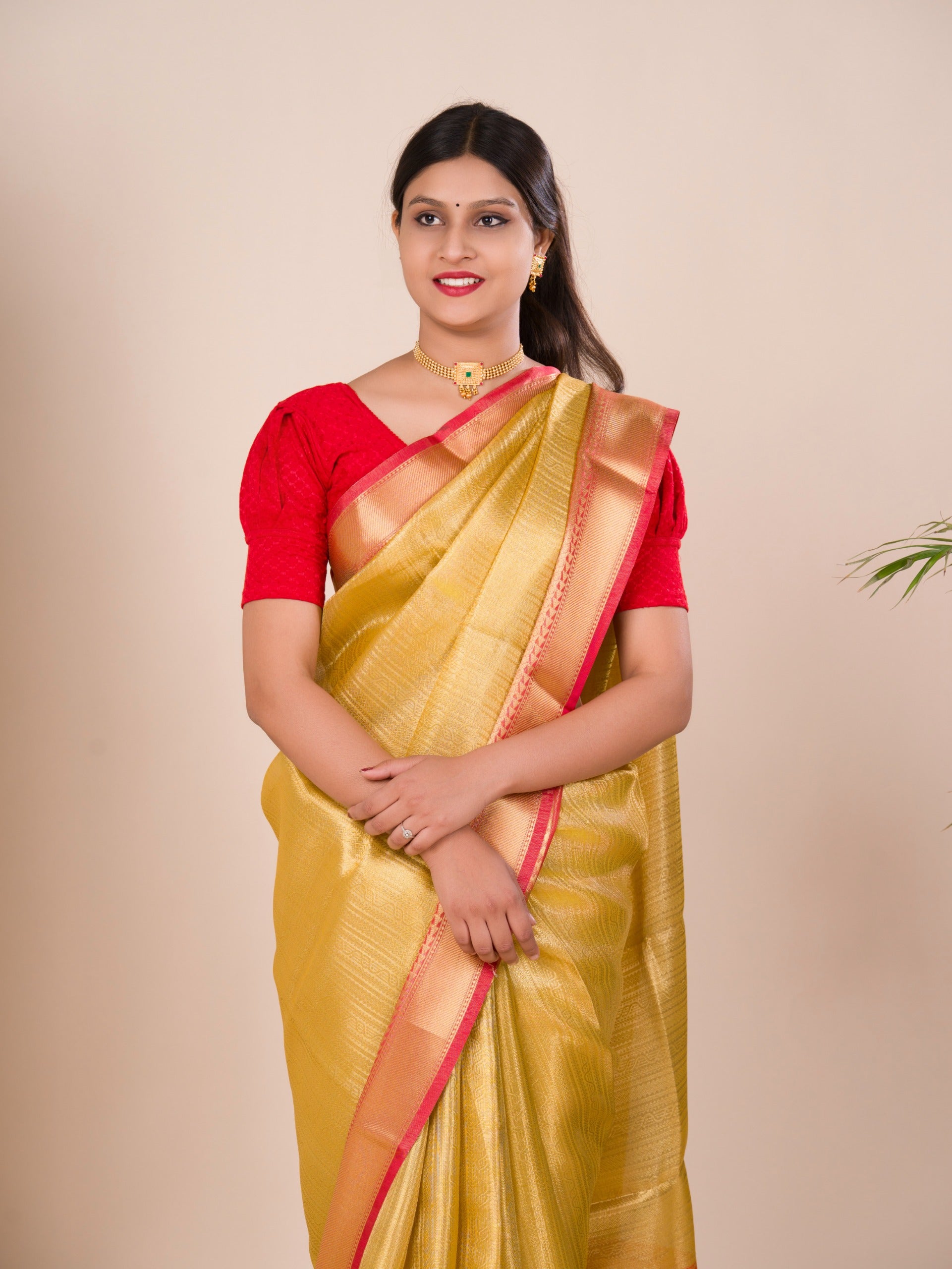 A Banarasi style saree in yellow and red with a tissue silk pattern, suitable for festival wear.