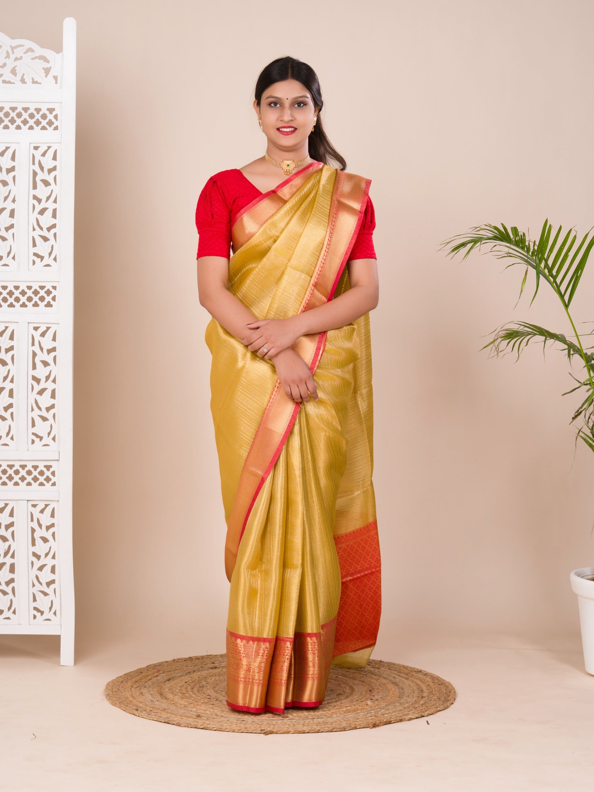 A Banarasi style saree in yellow and red with a tissue silk pattern, suitable for festival wear.