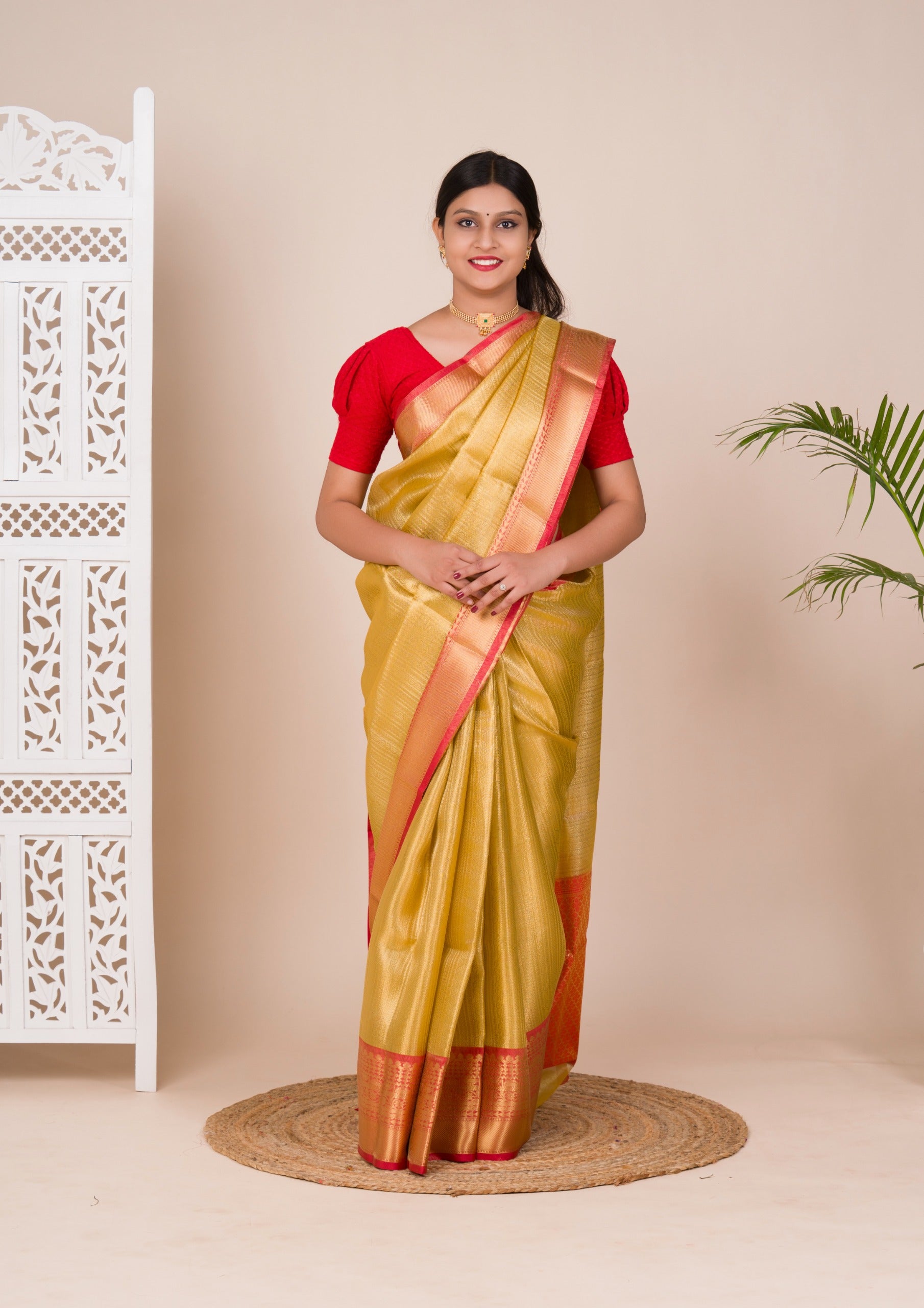 A Banarasi style saree in yellow and red with a tissue silk pattern, suitable for festival wear.