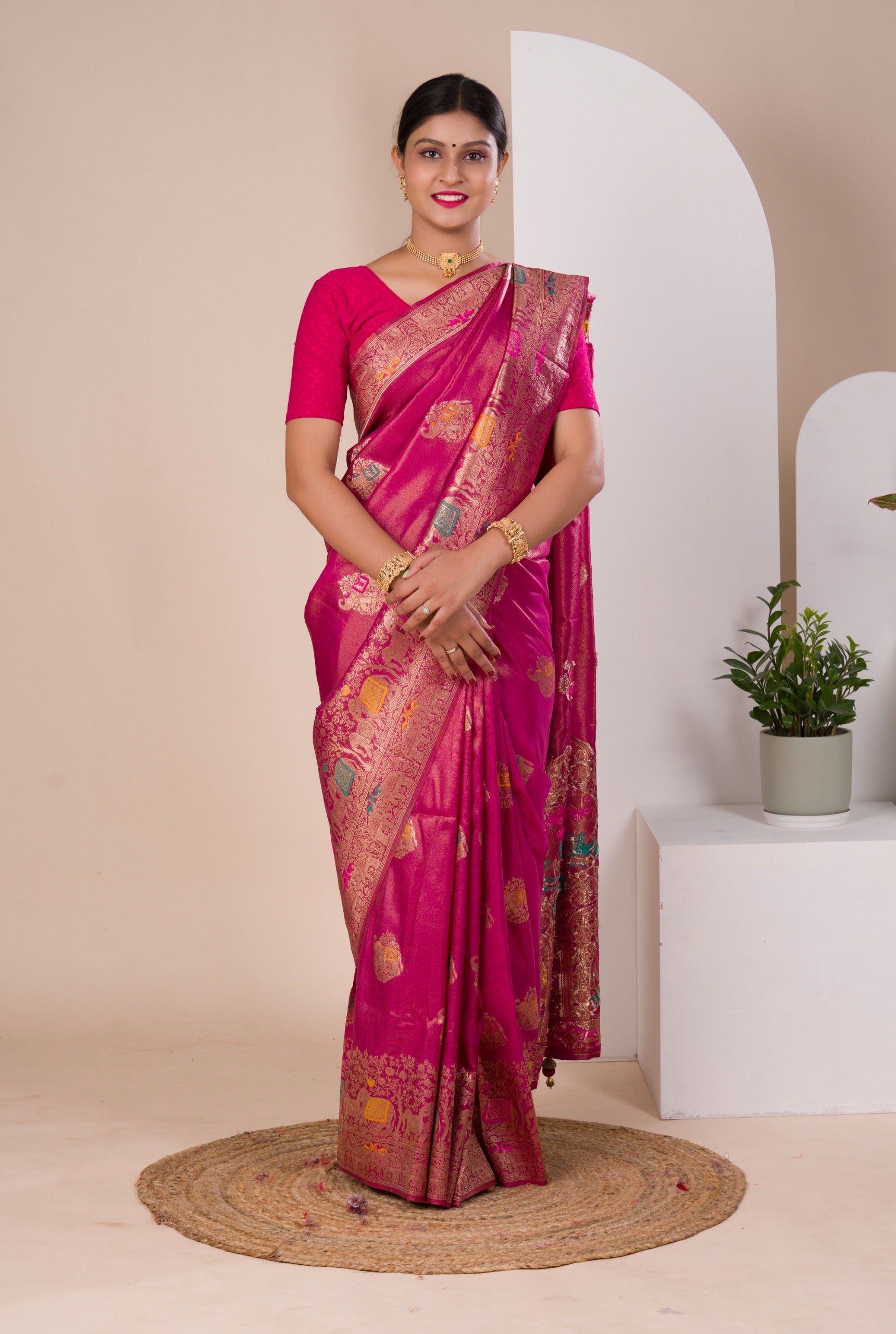 A pink Banarasi style saree with Meenakari weaving,