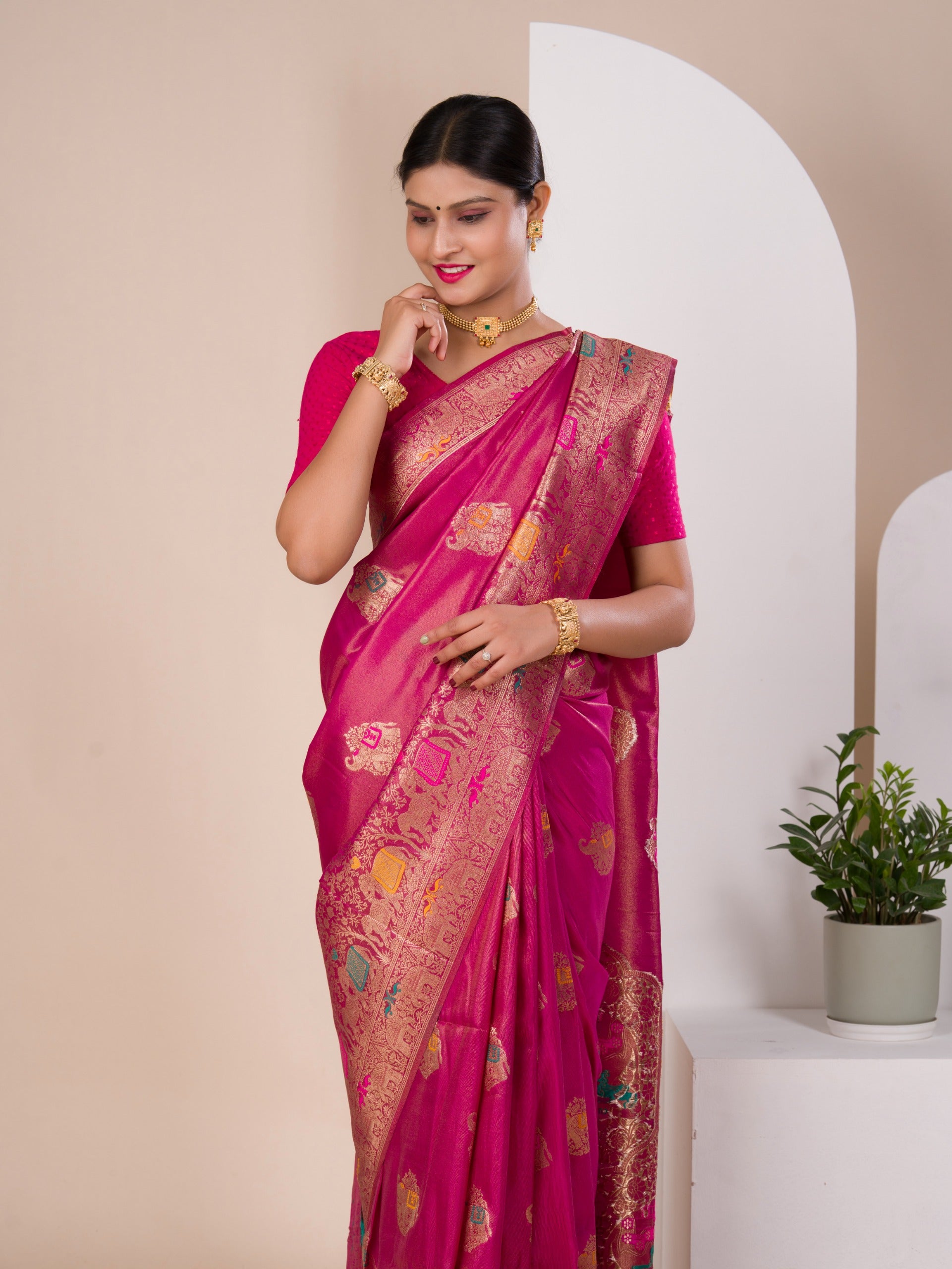 A pink Banarasi style saree with Meenakari weaving,