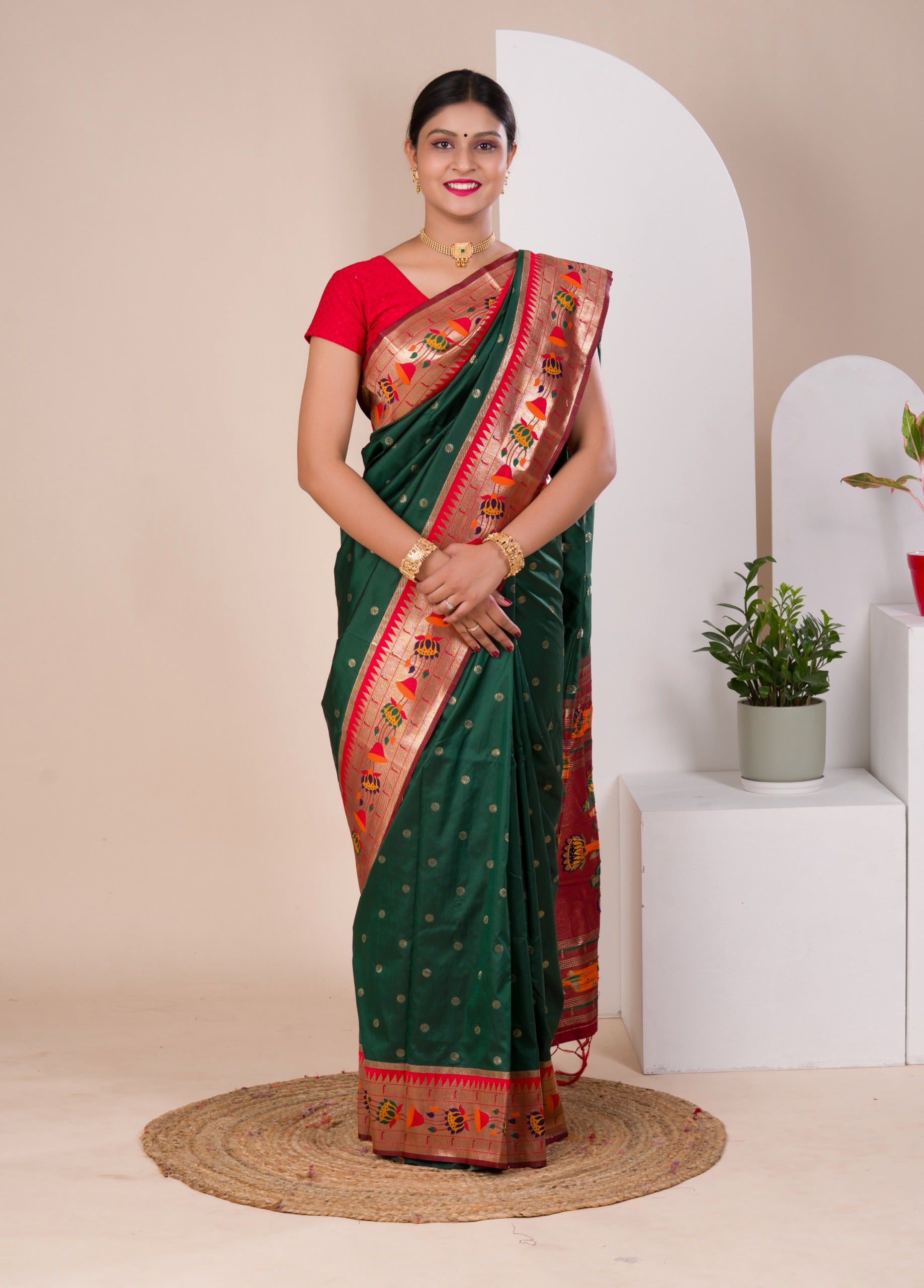 A green Paithani silk saree with a red zari border