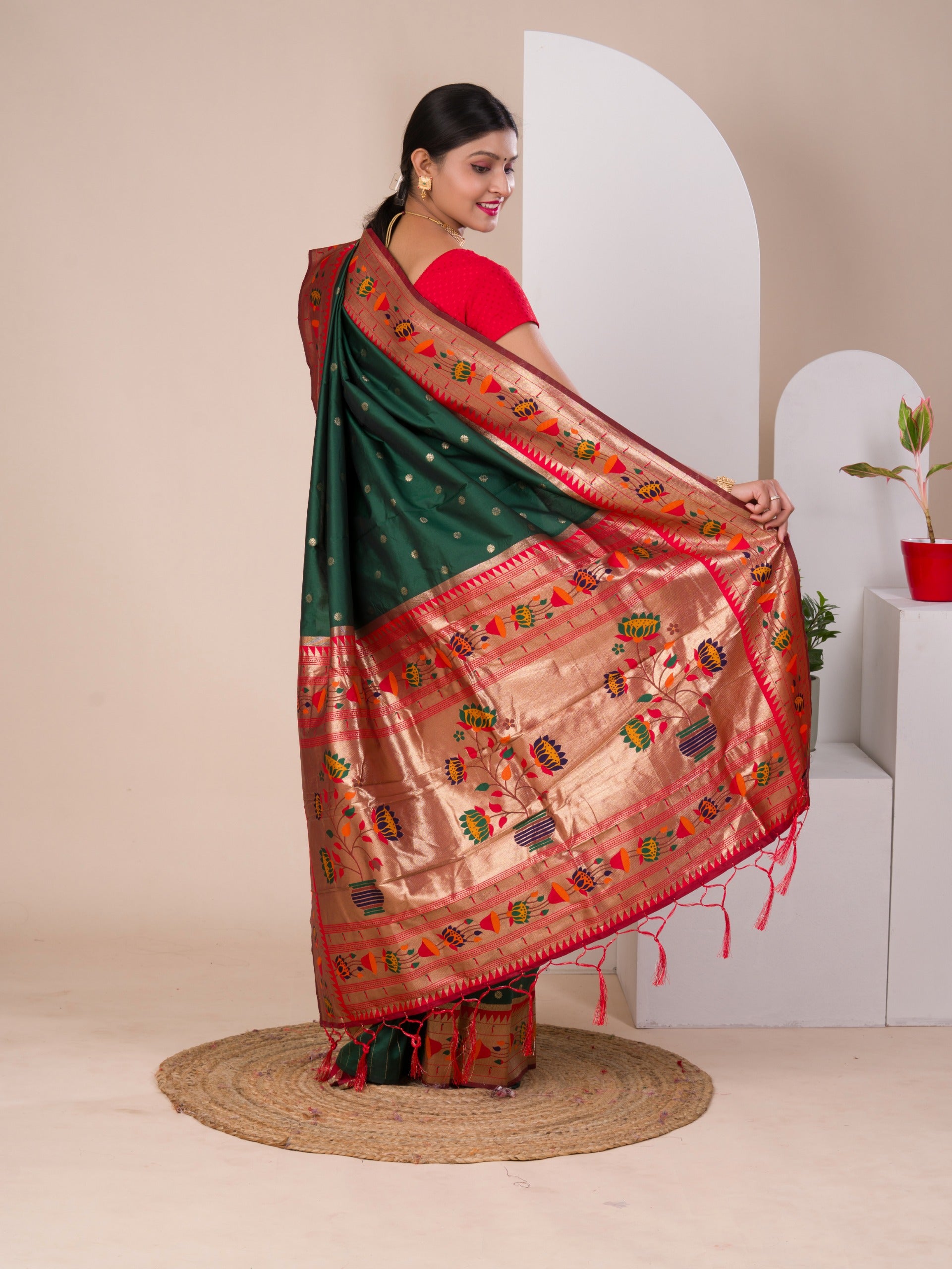 A green Paithani silk saree with a red zari border