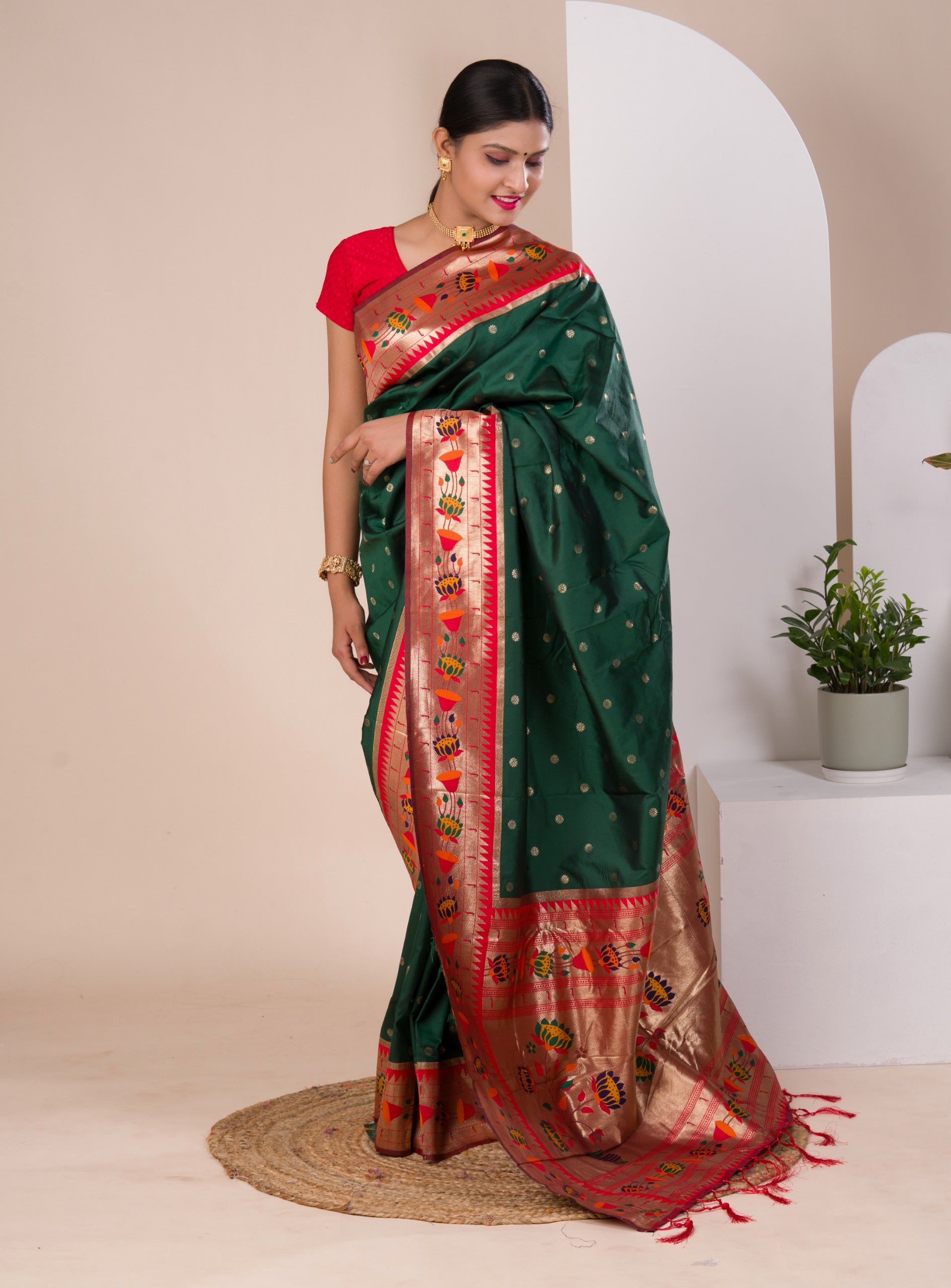A green Paithani silk saree with a red zari border