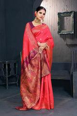 A red and pink Banarasi Dola silk saree with zari print, suitable for festive wear.
