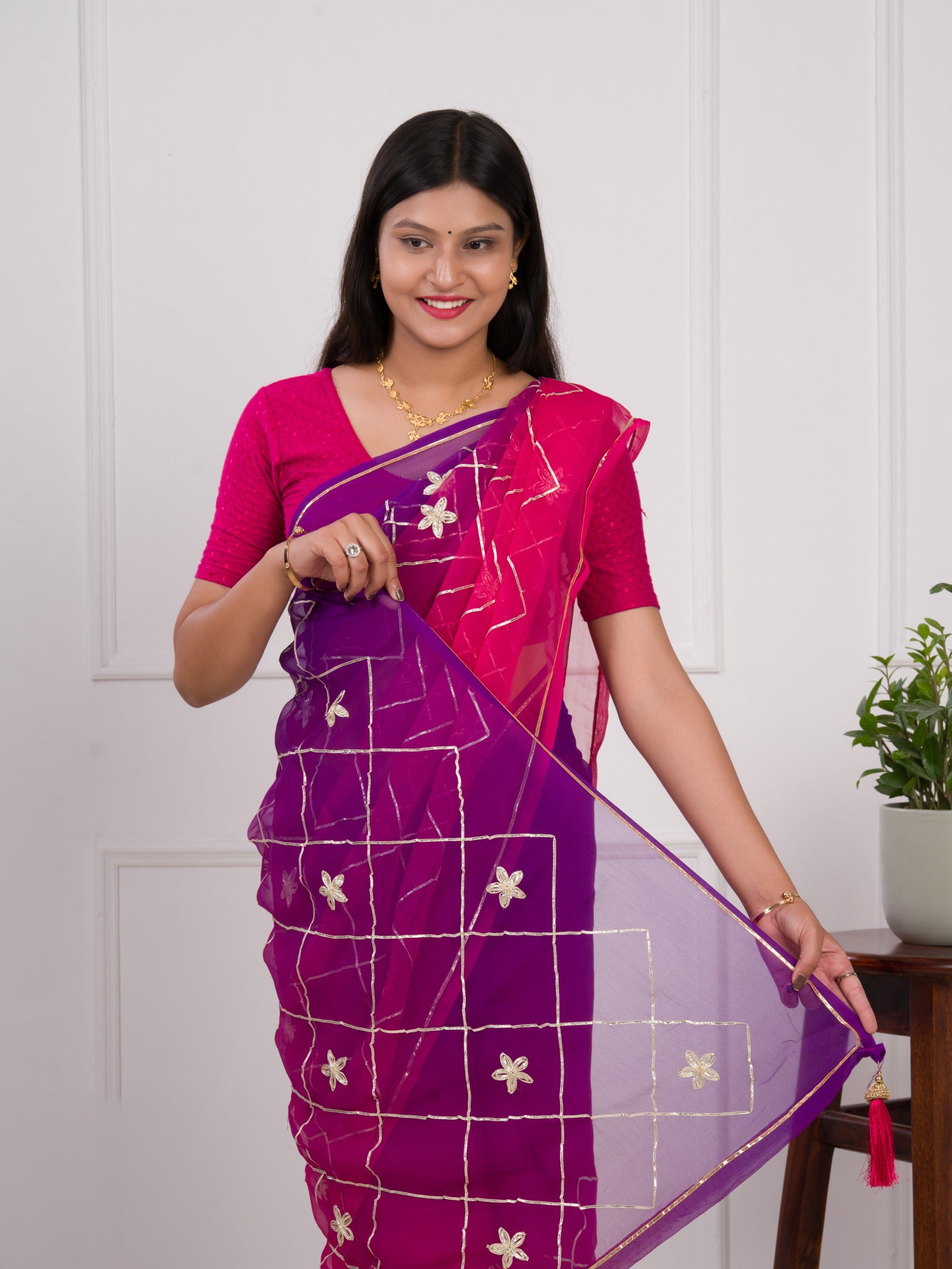 A pink and purple saree with a white pattern under 1000
