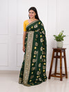 A green Dola silk saree with multi-colored bandhani style and Zari weaving work